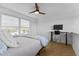 Bedroom features a ceiling fan, herringbone flooring, and a built-in desk at 320 W Martin St # 205, Raleigh, NC 27601