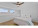 Bedroom with two windows, ceiling fan, herringbone floors, and light-colored walls at 320 W Martin St # 205, Raleigh, NC 27601