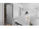 Upstairs hallway with bathroom and bedroom doors, recessed lights, and wood floors at 320 W Martin St # 205, Raleigh, NC 27601