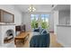Inviting living room with a blue couch, decorative fireplace, and large windows offering scenic views at 320 W Martin St # 205, Raleigh, NC 27601