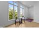 Bright living room with large windows, wood floors, and modern furniture at 320 W Martin St # 205, Raleigh, NC 27601