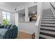 Open-concept living room with access to a modern kitchen and staircase at 320 W Martin St # 205, Raleigh, NC 27601