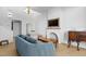 Cozy living room featuring a comfortable blue couch, modern lighting, and a charming fireplace with a television at 320 W Martin St # 205, Raleigh, NC 27601