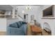 Bright living room with a stylish blue couch, unique lighting, and a decorative fireplace with a television at 320 W Martin St # 205, Raleigh, NC 27601