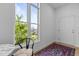 Bright, simple living area, with large windows, wood floors, rug and a single chair at 320 W Martin St # 205, Raleigh, NC 27601