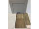 Display of gray cabinet, quartz countertop sample, and Shaw luxury vinyl driftwood flooring at 352 Chesapeak Commons St # 136, Garner, NC 27529