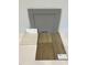 Sample of gray kitchen cabinet, quartz countertop, and luxury vinyl driftwood flooring at 352 Chesapeak Commons St # 136, Garner, NC 27529