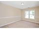 Neutral bedroom featuring a carpeted floor, and two windows at 3566 Sunbright Ln, Raleigh, NC 27610