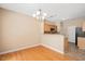 Inviting view of the dining area flowing into the kitchen, featuring hardwood floors and modern lighting at 3566 Sunbright Ln, Raleigh, NC 27610