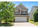 Two-story home featuring a two-car garage and an inviting front yard at 3566 Sunbright Ln, Raleigh, NC 27610