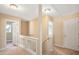 Upstairs hallway featuring a staircase and access to various rooms, offering a bright and airy feel at 3566 Sunbright Ln, Raleigh, NC 27610