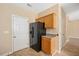 Practical kitchen space with black appliances, wooden cabinets, and easy access to additional areas at 3566 Sunbright Ln, Raleigh, NC 27610
