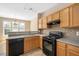 Functional kitchen featuring wood cabinets, a black range, and tile backsplash at 3566 Sunbright Ln, Raleigh, NC 27610