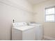 Functional laundry room featuring a washer, dryer, shelving and window at 3566 Sunbright Ln, Raleigh, NC 27610