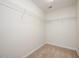 Spacious walk-in closet with white walls, neutral carpet, and metal shelving at 3566 Sunbright Ln, Raleigh, NC 27610