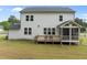 Home backyard featuring a patio and sunroom with chairs and a well-kept lawn at 386 The Parks Dr, Pittsboro, NC 27312