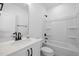 Clean white bathroom with a tub and shower combination, a vanity, and a toilet at 386 The Parks Dr, Pittsboro, NC 27312