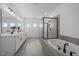 Bright bathroom with a double vanity, a freestanding tub, and a glass enclosed shower at 386 The Parks Dr, Pittsboro, NC 27312
