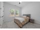 Bright bedroom with large windows, plush carpeting, and comfortable queen bed at 386 The Parks Dr, Pittsboro, NC 27312