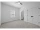 A clean and simple bedroom with a fan and connected bathroom at 386 The Parks Dr, Pittsboro, NC 27312
