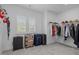 Walk-in closet with shelving and hanging racks for storage, plus a window for natural light at 386 The Parks Dr, Pittsboro, NC 27312