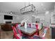 Open floorplan showing the dining room, modern lighting, adjacent kitchen with white cabinetry at 386 The Parks Dr, Pittsboro, NC 27312