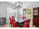 Bright dining room features modern lighting, sleek table, and chairs near sliding glass doors at 386 The Parks Dr, Pittsboro, NC 27312