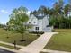Beautiful two-story home with a well-manicured lawn and a long driveway at 386 The Parks Dr, Pittsboro, NC 27312