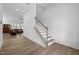 Inviting foyer with wood-look floors, staircase, and views of the living room at 386 The Parks Dr, Pittsboro, NC 27312