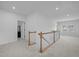 Upstairs hallway that features carpet, white walls, and wood-stained railings at 386 The Parks Dr, Pittsboro, NC 27312