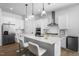 Spacious white kitchen with stainless steel appliances, a center island with seating, and modern fixtures at 386 The Parks Dr, Pittsboro, NC 27312