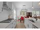 Stylish kitchen with white cabinets, stainless steel appliances, and a view of the dining area at 386 The Parks Dr, Pittsboro, NC 27312