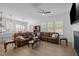 Open concept living area with modern finishes, fireplace, sleek tv, and wood floors at 386 The Parks Dr, Pittsboro, NC 27312