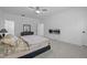 Bright primary bedroom with carpet, large windows, ceiling fan, closet, and bedside table at 386 The Parks Dr, Pittsboro, NC 27312
