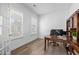 Bright home office with two windows, wood floors, and a traditional-style desk at 386 The Parks Dr, Pittsboro, NC 27312