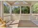 Covered screened porch with a beautiful view of the backyard and trees at 386 The Parks Dr, Pittsboro, NC 27312