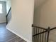 Upstairs view of stairway with gray flooring and black railings at 4004 Silver Oak Ln # 97, Durham, NC 27703
