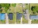 An aerial view shows neatly arranged houses with well-kept lawns and driveways in a quiet neighborhood at 404 W E St, Erwin, NC 28339