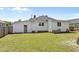 Home's backyard with white siding, providing a spacious outdoor area and access to the house at 404 W E St, Erwin, NC 28339
