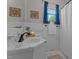 Cozy bathroom featuring a window, a vanity with gold accents, and a shower with a white curtain at 404 W E St, Erwin, NC 28339