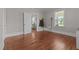 Bedroom featuring hardwood floors, a window, and an open doorway into another room at 404 W E St, Erwin, NC 28339