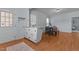 A dining area with wood floors, a table with chairs, and a view into the kitchen at 404 W E St, Erwin, NC 28339