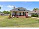 Charming single-story home with a welcoming porch, brick accents, and a well-manicured lawn at 404 W E St, Erwin, NC 28339