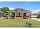 Charming home featuring a brick front porch, lawn, and cozy seating, inviting relaxation and curb appeal at 404 W E St, Erwin, NC 28339