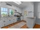 Charming kitchen featuring white cabinets, granite countertops, stainless steel appliances, and wood flooring at 404 W E St, Erwin, NC 28339