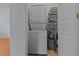 Practical laundry area featuring a stackable washer and dryer unit and shelving for storage at 404 W E St, Erwin, NC 28339