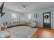 Cozy living room with light blue walls, hardwood floors, neutral furniture, and natural light from multiple windows at 404 W E St, Erwin, NC 28339