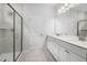 Modern bathroom showcasing a double sink vanity, walk-in shower, and updated fixtures, with decorative gray tiling at 425 Providence Springs Ln, Fuquay Varina, NC 27526
