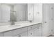 A well-lit bathroom with double sinks, white cabinets, and modern fixtures, offers a clean aesthetic at 425 Providence Springs Ln, Fuquay Varina, NC 27526