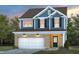 Charming two-story home with a brick and siding exterior, featuring a two-car garage and professionally landscaped yard at 425 Providence Springs Ln, Fuquay Varina, NC 27526